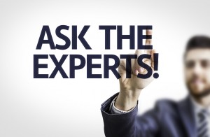 Business man pointing the text: Ask the Experts!